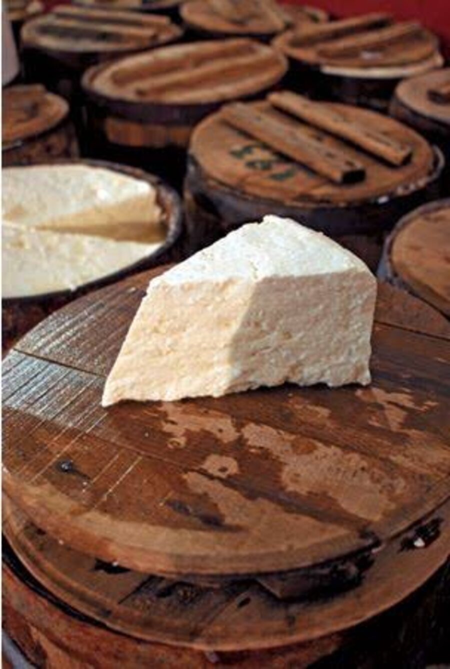 Block of barrel-aged Greek feta on a wooden board